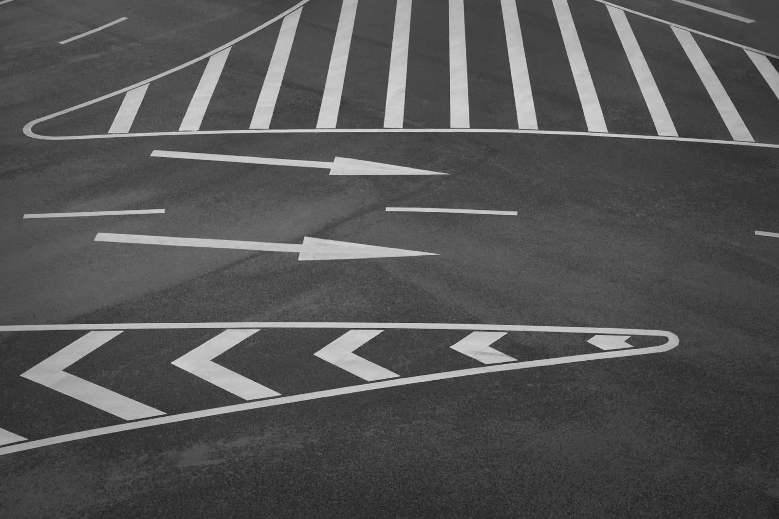 Directional traffic lines applied to asphalt roadways.